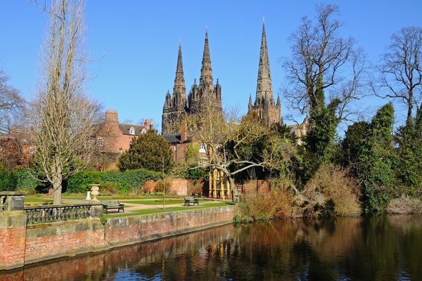 Lichfield cathedral in front of a pool